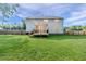 View of the home's rear exterior featuring a well-maintained lawn and wood fence at 2802 Bingham Dr, Mebane, NC 27302