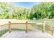 Spacious backyard with a wood fence, lush greenery, and a storage shed at 2802 Bingham Dr, Mebane, NC 27302