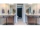 Bright bathroom with double vanity sinks, mirrors, and a stylish shower at 2802 Bingham Dr, Mebane, NC 27302