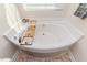 Corner bathtub featuring a chrome faucet, perfect for relaxation and luxury at 2802 Bingham Dr, Mebane, NC 27302