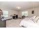 Bright bedroom with carpet, two windows, and a workstation desk at 2802 Bingham Dr, Mebane, NC 27302