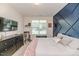 Bedroom featuring a custom accent wall and a large window at 2802 Bingham Dr, Mebane, NC 27302