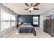 This bedroom features a ceiling fan, large windows, and stylish decor at 2802 Bingham Dr, Mebane, NC 27302
