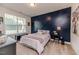 Bedroom featuring a custom accent wall and lots of natural light at 2802 Bingham Dr, Mebane, NC 27302