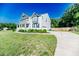 Charming two-story home with a well-manicured lawn and inviting curb appeal with a long driveway at 2802 Bingham Dr, Mebane, NC 27302
