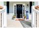 Welcoming front porch adorned with patriotic decor and lush potted plants at 2802 Bingham Dr, Mebane, NC 27302