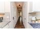 Hallway with hardwood floors connecting the kitchen area, offering access to other parts of the home at 2802 Bingham Dr, Mebane, NC 27302