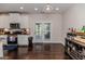 Well-lit kitchen with granite counters, stainless steel appliances, and access to the outdoor patio at 2802 Bingham Dr, Mebane, NC 27302