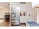 Kitchen area with stainless steel refrigerator and adjacent cabinets with granite countertops at 2802 Bingham Dr, Mebane, NC 27302