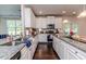 View of kitchen with white cabinets, granite countertops and stainless appliances at 2802 Bingham Dr, Mebane, NC 27302