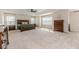 Spacious main bedroom featuring a trey ceiling, plush carpeting, and abundant natural light from bright windows at 2802 Bingham Dr, Mebane, NC 27302