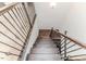 Elegant staircase with wrought iron railing and hardwood steps leading to the upper level at 2802 Bingham Dr, Mebane, NC 27302