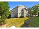 Exterior showing the backyard with a patio, grassy area, and the side of a townhome at 2821 Corbett Grove Dr, Raleigh, NC 27604