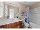 Bathroom featuring a wooden vanity, mirror, and bathtub with shower and tiled floor at 2821 Corbett Grove Dr, Raleigh, NC 27604