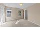 Bright, neutral bedroom with carpet, windows, and access to closet and door to bathroom at 2821 Corbett Grove Dr, Raleigh, NC 27604