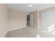 Neutral carpeted bedroom with a closet and a door that leads to an adjacent bathroom at 2821 Corbett Grove Dr, Raleigh, NC 27604