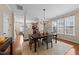 Bright dining area with an open floor plan, hardwood floors, and an elegant chandelier at 2821 Corbett Grove Dr, Raleigh, NC 27604