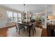 Open dining area with hardwood floors, chandelier, and view to the living room at 2821 Corbett Grove Dr, Raleigh, NC 27604