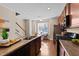 Open-concept kitchen featuring modern appliances and hardwood floors, with direct access to the backyard at 2821 Corbett Grove Dr, Raleigh, NC 27604