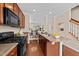 Well-equipped kitchen with a breakfast bar, leading into the dining and living areas at 2821 Corbett Grove Dr, Raleigh, NC 27604