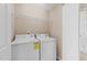 Laundry room featuring a white washer and dryer, along with wire shelving for storage at 2821 Corbett Grove Dr, Raleigh, NC 27604