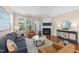 Stylish living room with hardwood floors, a fireplace, a cozy couch, and natural light at 2821 Corbett Grove Dr, Raleigh, NC 27604