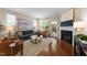 Comfortable living room featuring hardwood floors, natural light, a fireplace, and stylish furnishings at 2821 Corbett Grove Dr, Raleigh, NC 27604
