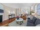 Inviting living room featuring hardwood floors, a fireplace, and open view to dining area at 2821 Corbett Grove Dr, Raleigh, NC 27604