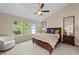 Bright main bedroom with lots of natural light, ceiling fan, and comfortable seating area at 2821 Corbett Grove Dr, Raleigh, NC 27604