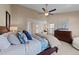 Comfortable main bedroom with warm neutral tones, large bed, dresser, and a dedicated sitting area at 2821 Corbett Grove Dr, Raleigh, NC 27604