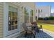 Cozy patio with outdoor seating and a view of the backyard and neighboring home at 2821 Corbett Grove Dr, Raleigh, NC 27604