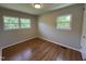 Bedroom with hardwood floors and two windows offering natural light at 2909 Sprucewood Dr, Durham, NC 27707