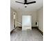 Bonus room with ceiling fan; carpet covered with plastic at 2909 Sprucewood Dr, Durham, NC 27707