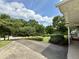 Long driveway leads to landscaped front yard with mature trees surrounding property at 2909 Sprucewood Dr, Durham, NC 27707