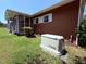 Exterior view of home featuring screened porch, backyard, and emergency power generator at 2909 Sprucewood Dr, Durham, NC 27707