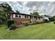 Charming home with manicured lawn, mature trees, and flowering shrubbery at 2909 Sprucewood Dr, Durham, NC 27707
