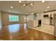 Open concept living space with hardwood floors leading to a modern kitchen with stainless appliances at 2909 Sprucewood Dr, Durham, NC 27707