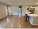 Open-concept living space with modern kitchen featuring an island with seating and stainless appliances at 2909 Sprucewood Dr, Durham, NC 27707