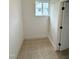 Bright mud room with tan tile flooring and convenient access to exterior light at 2909 Sprucewood Dr, Durham, NC 27707