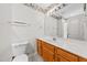 Bathroom with oak vanity, expansive mirror, and neutral color palette at 3027 Maple # T1, Burlington, NC 27215