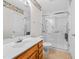 Bright bathroom with shower, white fixtures, framed mirror, and floral wallpaper border at 3027 Maple # T1, Burlington, NC 27215