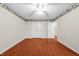 Bedroom featuring wood-look floors, floral wallpaper border, and a double door closet at 3027 Maple # T1, Burlington, NC 27215