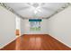 Bright bedroom with ceiling fan, wood-look floors, and floral wallpaper border at 3027 Maple # T1, Burlington, NC 27215