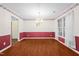 A spacious dining room is brightly lit by a chandelier and natural light from the window at 3027 Maple # T1, Burlington, NC 27215