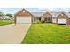 Well-maintained brick home with a two-car garage and manicured lawn at 3027 Maple # T1, Burlington, NC 27215