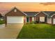 Charming brick home with manicured lawn and attached two-car garage, offering great curb appeal at 3027 Maple # T1, Burlington, NC 27215