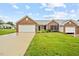 Beautiful single-story brick house with a lush green lawn and inviting curb appeal at 3027 Maple # T1, Burlington, NC 27215