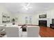 Bright living room with a fireplace, ceiling fan, hardwood floors, and double doors to the exterior at 3027 Maple # T1, Burlington, NC 27215
