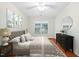 Cozy bedroom with a plush bed, dresser, ample pillows, natural light, and a ceiling fan at 3027 Maple # T1, Burlington, NC 27215