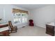 Bedroom with large window, plush carpet, and antique furniture providing a cozy ambiance at 303 Spring St, Louisburg, NC 27549